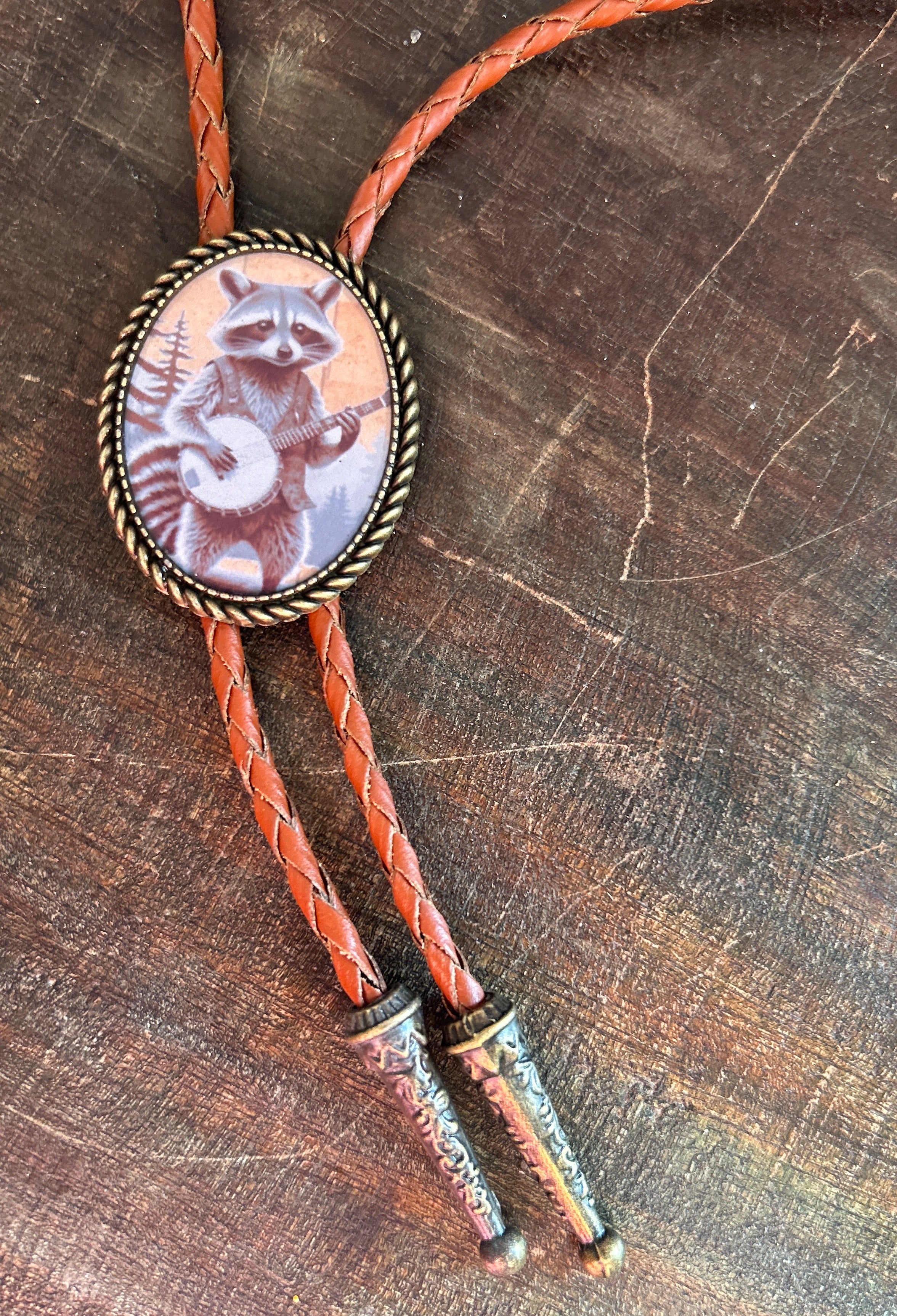 Banjo Raccoon Bolo Tie - cream background