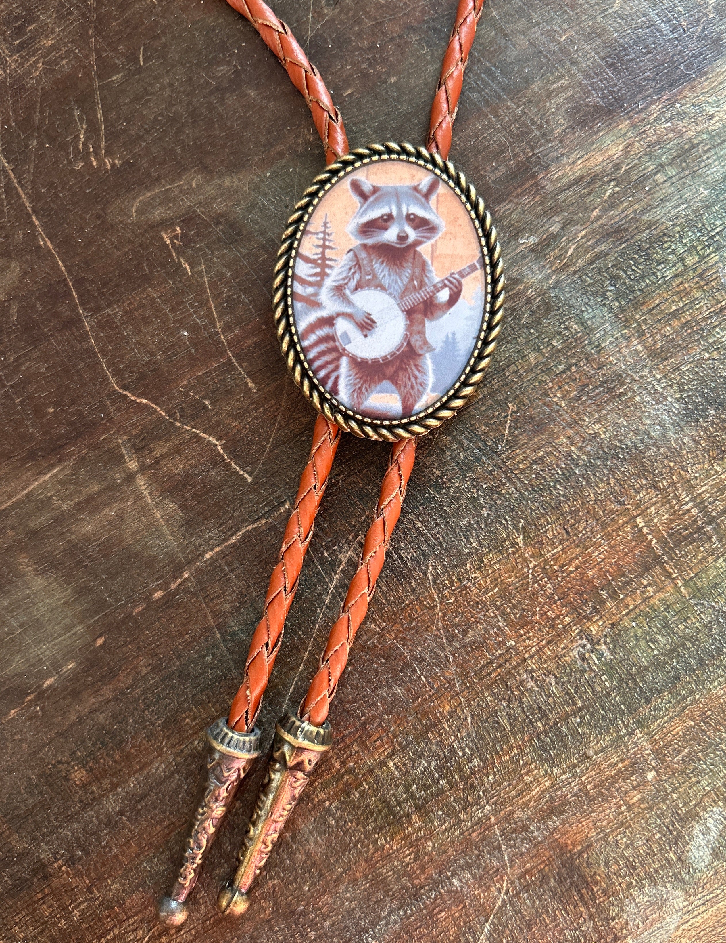 Banjo Raccoon Bolo Tie - cream background