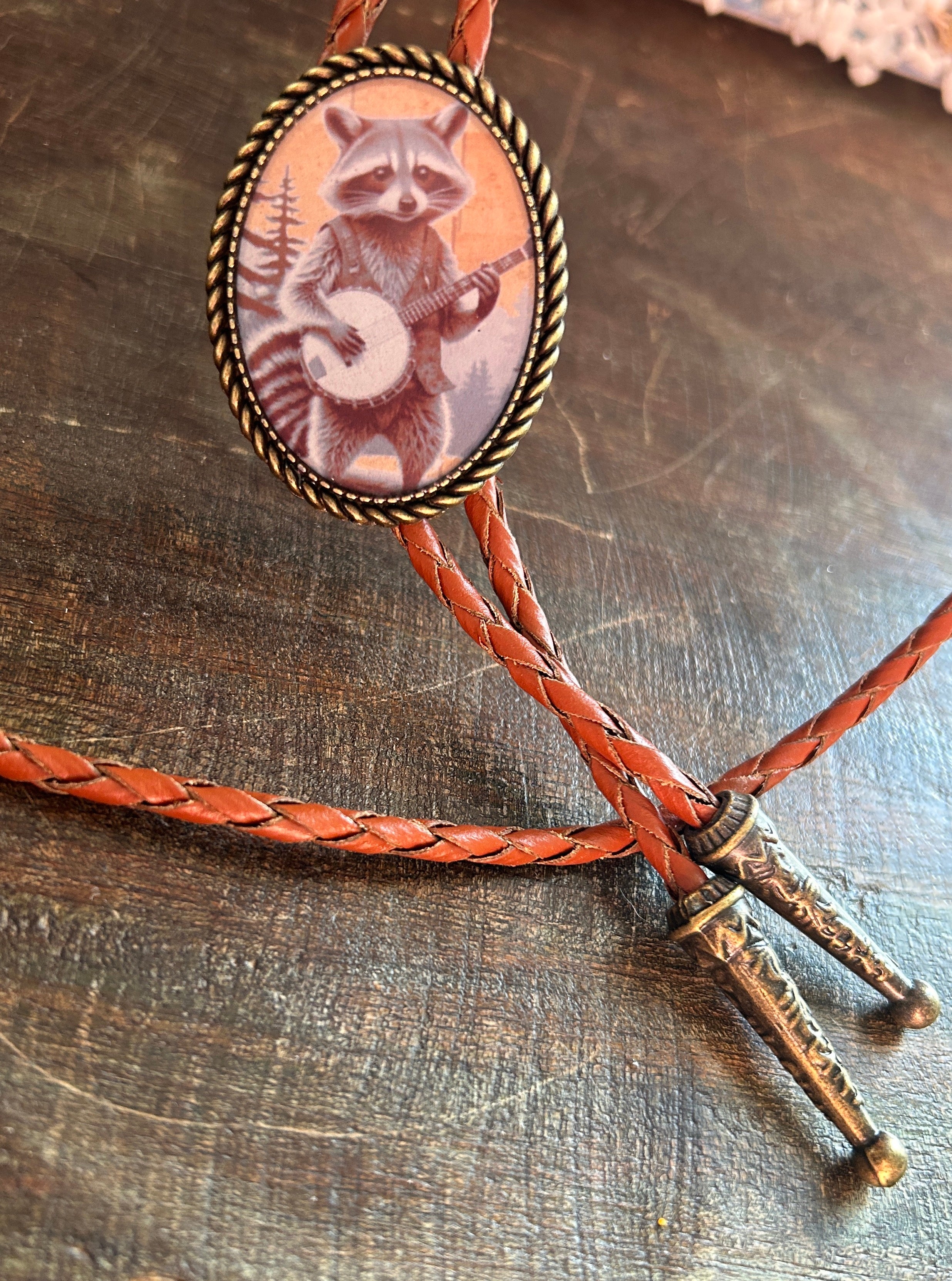 Banjo Raccoon Bolo Tie - cream background